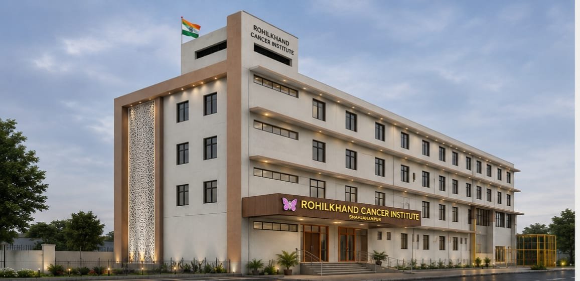 Rohilkhand Cancer Institute Shahjahanpur — new building at dusk with pink butterfly signage